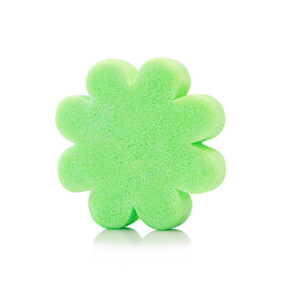 Green flower-shaped eco sponge on a white background