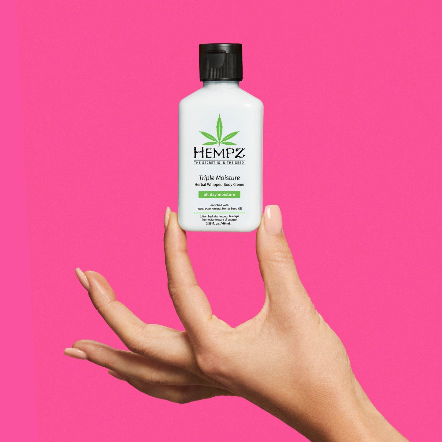 Model holding Hempz Travel-Size Hempz Triple Moisture Herbal Whipped Body Creme Lotion