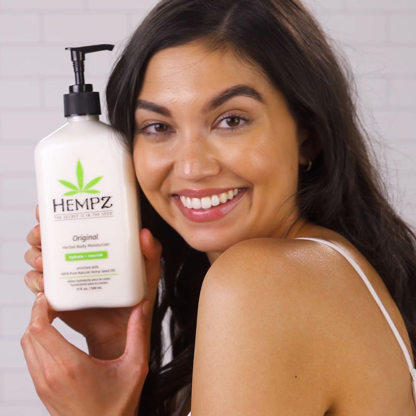 Model holding Original Moisturizing Lotion