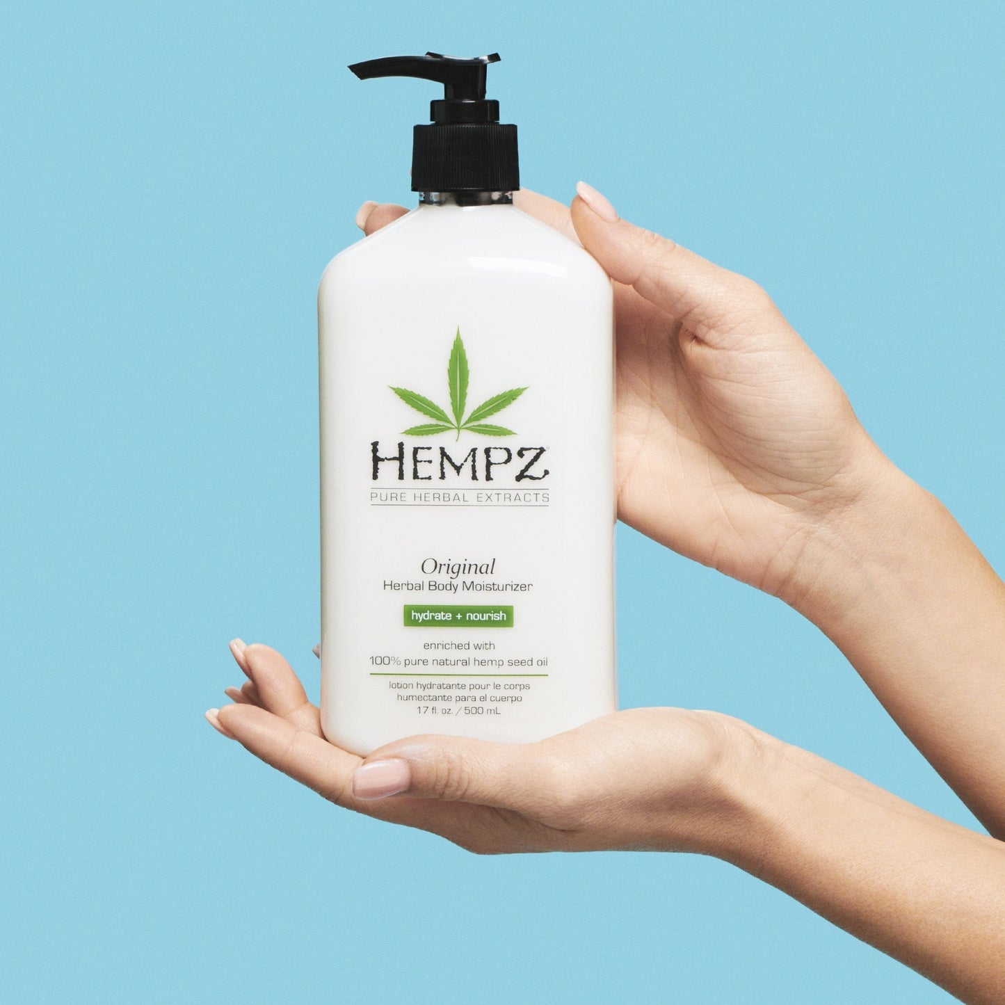 Model holding Hempz Original Herbal Body Moisturizer