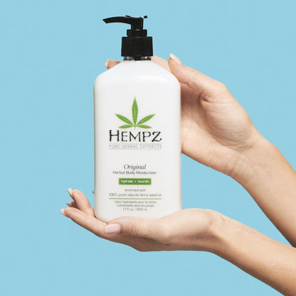 Model holding Hempz Original Herbal Body Moisturizer