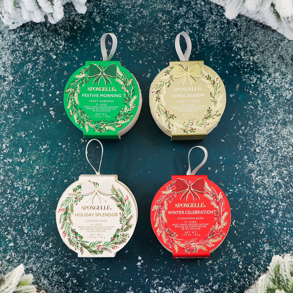 Four decorative holiday wreath body buffers with festive designs on a textured green background.