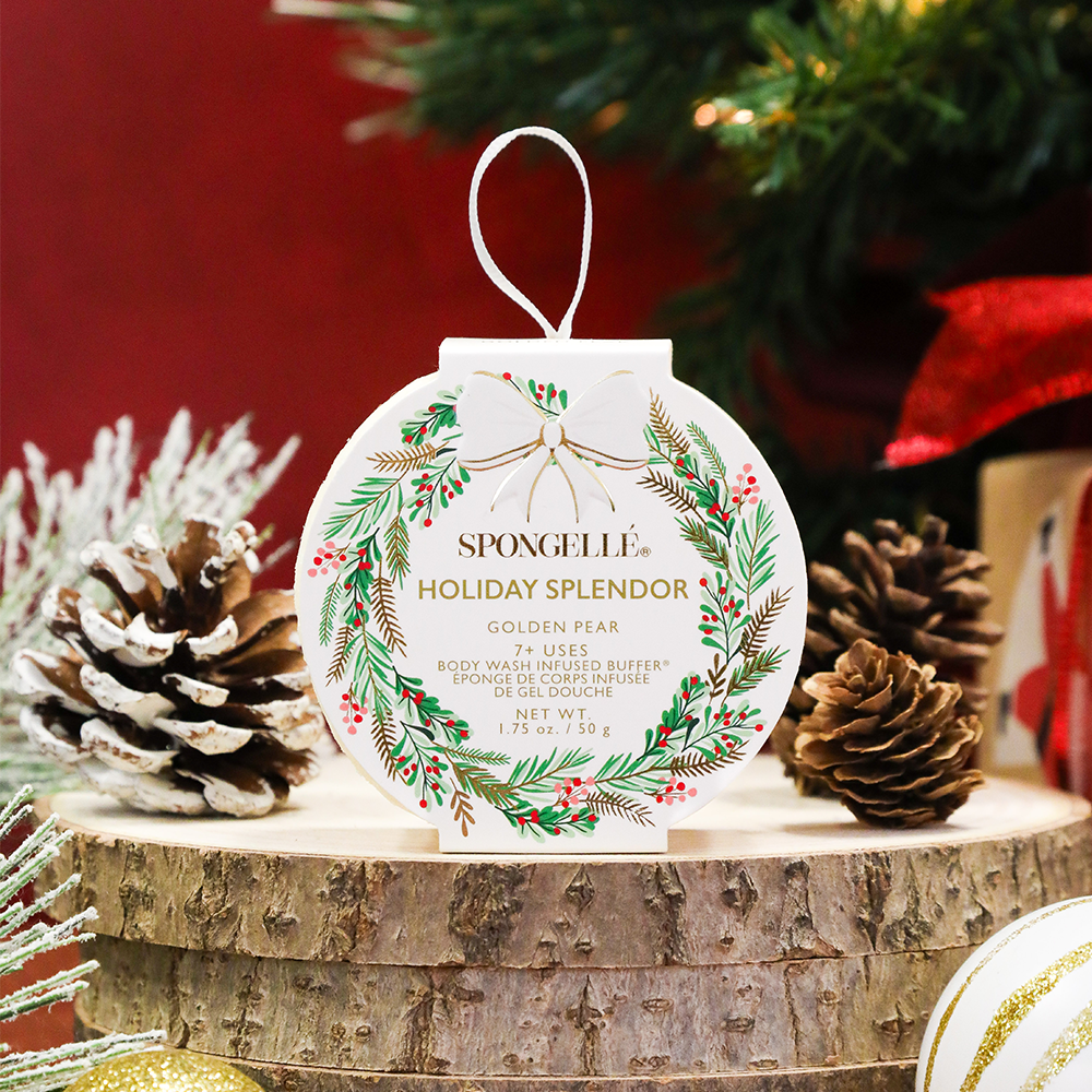 Spongelle Holiday Splendor body buffer with decorative elements on a wooden surface.