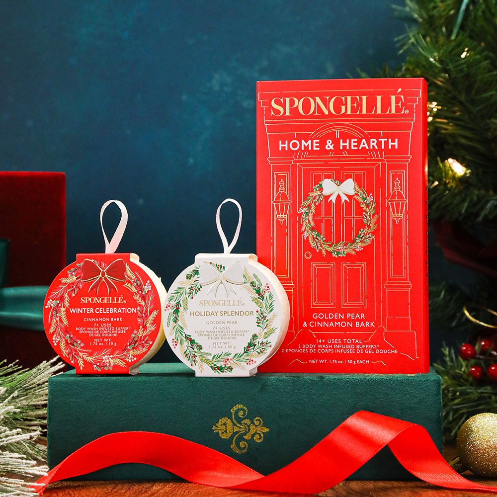 Spongellé holiday-themed Home & Hearth body buffer gift set including a box and two ornaments on a decorative stand.